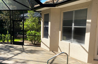 Woman installing hurricane shutters